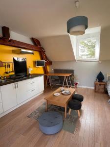 a living room with a table and a kitchen at Studio 61 in Angers