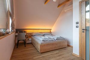 a small bedroom with a bed in a attic at Zielone Wzgórze Sidzina in Sidzina +44 photos