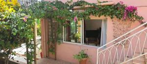 a house with a balcony with flowers on it at Mary Madinina in Fort-de-France