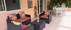 a patio with two couches and a table and chairs at Mary Madinina in Fort-de-France +21 photos