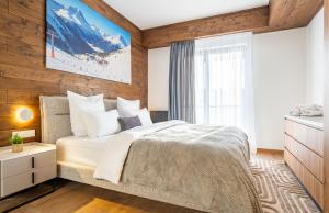 a bedroom with a large bed and a window at Winterfell in New Gudauri in Gudauri