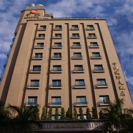 a tall building with a sign on top of it at Chong Yu Hotel in Taoyuan