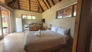 a bedroom with a bed and a kitchen at Lush Horizons Game Lodge in Modimolle +214 photos