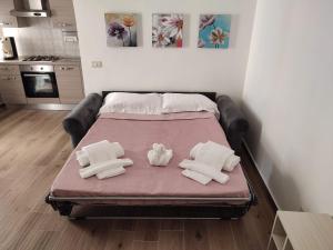 a bed with two white pillows on top of it at Al Quindici in Gaeta