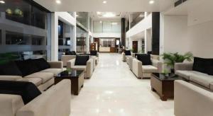 a lobby with couches and tables in a building at Hotel Horison Sagita Balikpapan in Klandasan Kecil