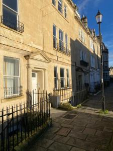 a building with a fence in front of it at Chic Georgian Escape near Royal Crescent in Bath