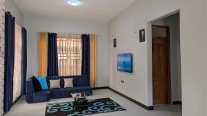 Dans place في موشي: غرفة معيشة مع أريكة زرقاء وسجادة