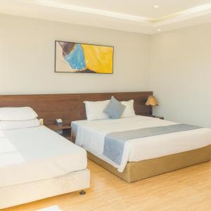 Una cama o camas en una habitación de An Tín Hotel