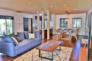 a living room with a blue couch and a table at Villa MILA ONNA in Onna