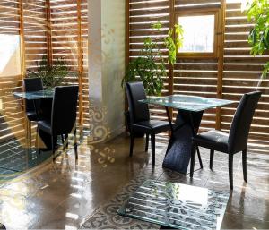 a restaurant with two tables and chairs and a window at X Hotel in Saviano