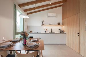 a kitchen with a wooden table and a dining room at Cabañas Ribeira Sacra in Parada del Sil +24 photos