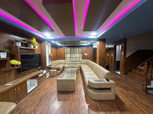 a living room with a couch and a tv at Entire Home in Kathmandu, Grace - Residential in Kathmandu