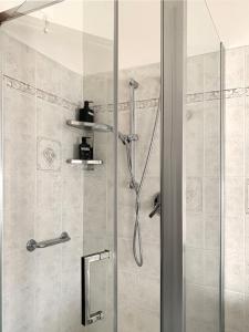 a bathroom with a shower with a glass door at Mini Suite Cremona in Cremona