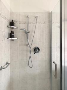 a shower with a glass door in a bathroom at Mini Suite Cremona in Cremona +14 photos