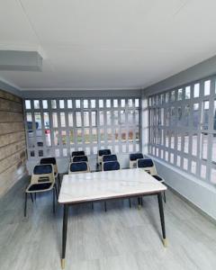 a room with a table and chairs in a building at Bethel house ruiru in Ruiru