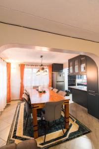 a kitchen and dining room with a wooden table at Bethel house ruiru in Ruiru