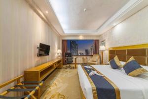 a hotel room with a large bed and a television at Xiamen Plaza Hotel in Xiamen