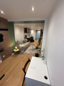 a living room with a couch and a table at Studio Bagneux Bourg la Reine in Bagneux