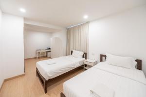 Giường trong phòng chung tại We Inn +2 ảnh