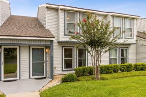 a house with a tree in the front yard at Pet Friendly Beach Retreat - Fernandina Shores - 6355 in Fernandina Beach
