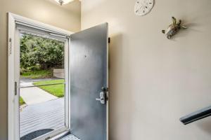 an open door with a clock on the wall at Pet Friendly Beach Retreat - Fernandina Shores - 6355 in Fernandina Beach