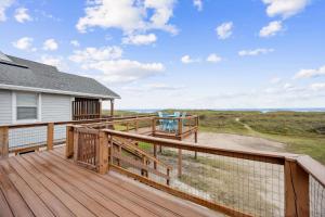 a deck with a view of a house at Spacious Beachfront Duplex - Top Floor - Dog Friendly - 124 S Fletcher in Fernandina Beach +35 photos