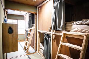 a room with two bunk beds and a bed in it at Guest house SENWA in Yuzawa