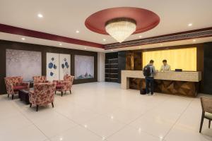 a man standing at a counter in a hotel lobby at Hotel Goodwill in Kaithal