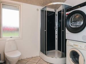 a laundry room with a washer and dryer at 4 star holiday home in Ansager in Ansager +30 photos