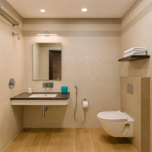 a bathroom with a sink and a toilet and a mirror at Hotel Goodwill in Kaithal