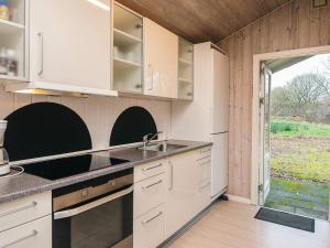 a kitchen with white cabinets and a sink at 4 star holiday home in Ansager in Ansager