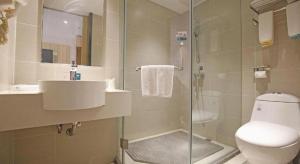a bathroom with a toilet and a sink and a shower at City Comfort Inn Chengdu Longquanyi District Beijing Road in Chengdu +140 photos