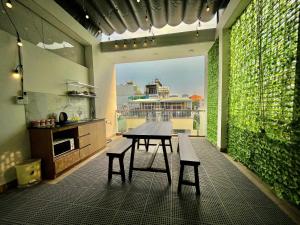 a kitchen with a table and benches in a room at AP Home in Ho Chi Minh City