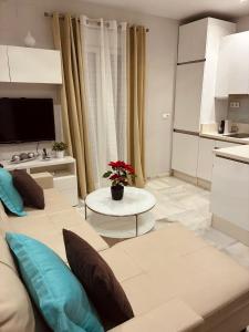 a living room with a couch and a table at Apartamento Castillo San Marcos in El Puerto de Santa María +14 photos