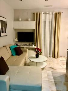 a living room with a couch and a table at Apartamento Castillo San Marcos in El Puerto de Santa María