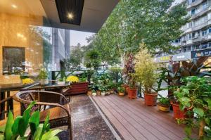 a balcony with a bunch of potted plants at Hangzhou Bokai Westlake Hotel in Hangzhou