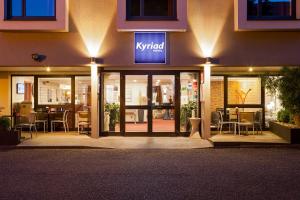 a building with a sign on the front of it at Kyriad Hotel Strasbourg Lingolsheim in Lingolsheim