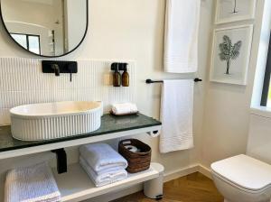 a bathroom with a sink and a mirror at Ibis Cottage Hout Bay with Mountain View Terrace in Hout Bay