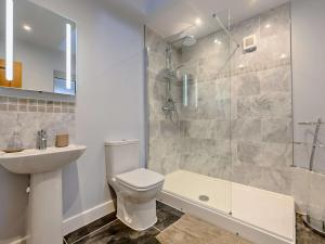 a bathroom with a toilet and a shower and a sink at 3 Bed in Keswick oc-93589 in Threlkeld +27 photos