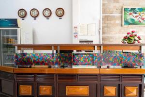 a counter in a store with clocks on the wall at Đình Đinh Hotel in Ho Chi Minh City