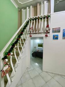 a room with a staircase with christmas decorations at Seventeen Home in Naples +57 photos