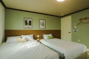 Ένα ή περισσότερα κρεβάτια σε δωμάτιο στο Hongdae Mangwon 3BR Apartment