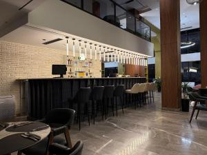 a restaurant with a bar with black stools at Afrosiyob in Stantsiya Kyzyl-Tukumachi