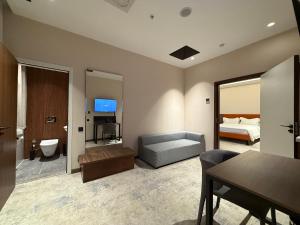 a living room with a bed and a dining room at Afrosiyob in Stantsiya Kyzyl-Tukumachi