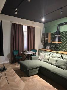 a bedroom with a bed and a table with chairs at Luxury City Apartments in Baku