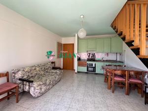 a living room with a couch and a table at Campanile in San Vincenzo