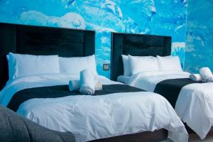 zwei Betten mit ausgestopften Tieren in einem Schlafzimmer in der Unterkunft Meriam Base Lodge in Kempton Park