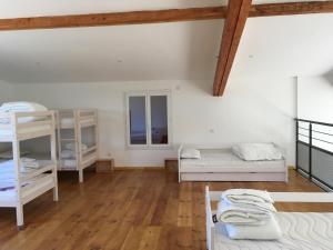 a room with bunk beds and a wooden floor at Domaine de Montels in Albias +11 photos