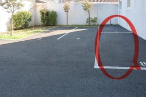 Een rode cirkel bevindt zich op een parkeerplaats. bij Cenon plein ciel in Cenon +2 foto's