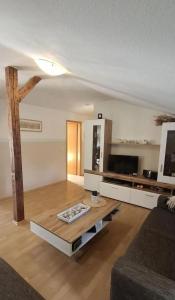 a living room with a couch and a coffee table at Kleine Strandperle in Fehmarn